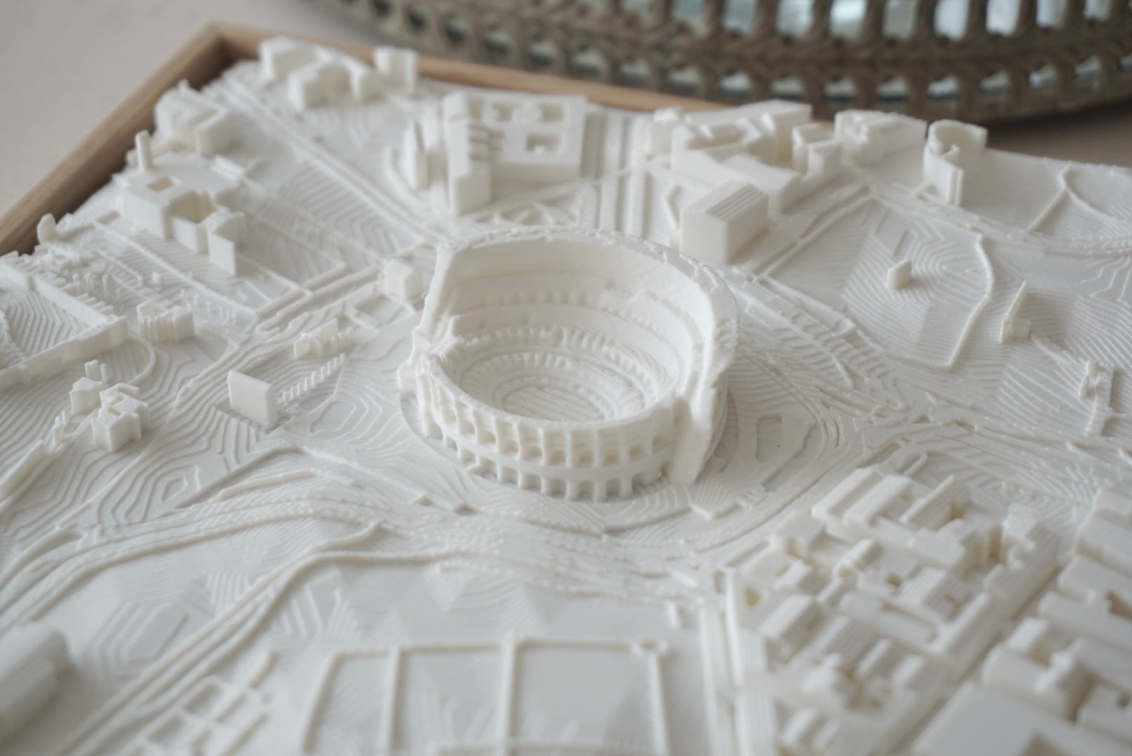 3D city map art featuring a detailed stadium and surrounding urban landscape