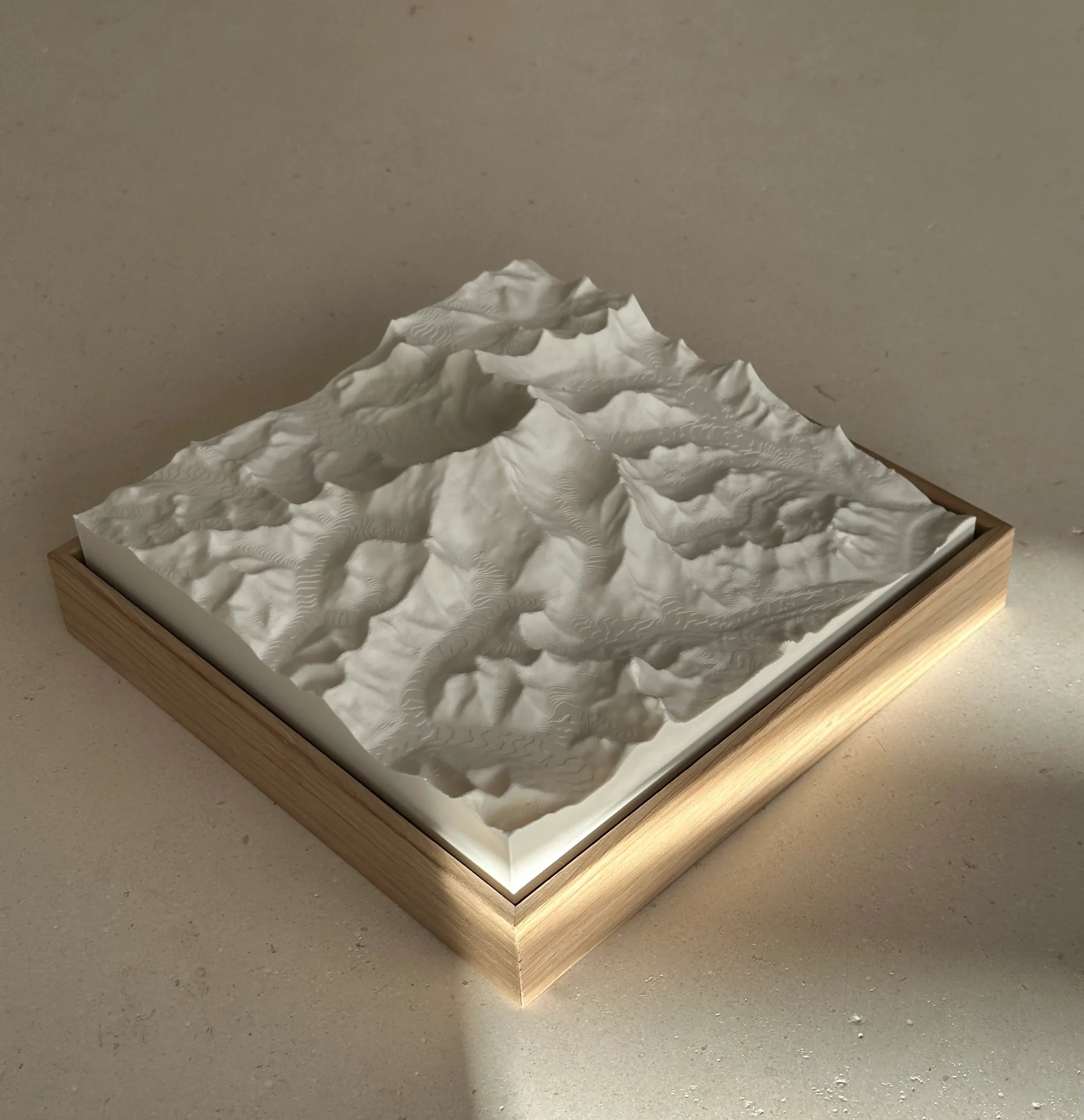 3D topographic map artwork in a wooden frame, minimalist mountain wall decor