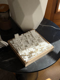 3D city map art in a wooden frame on a black marble table, modern home decor