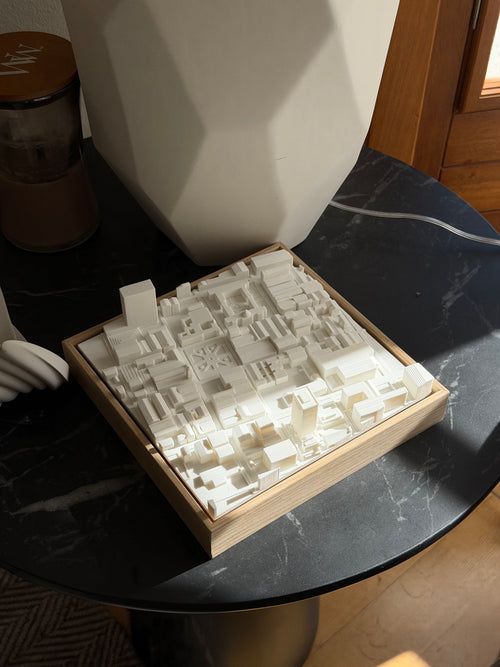 3D city map art in a wooden frame on a black marble table, modern home decor