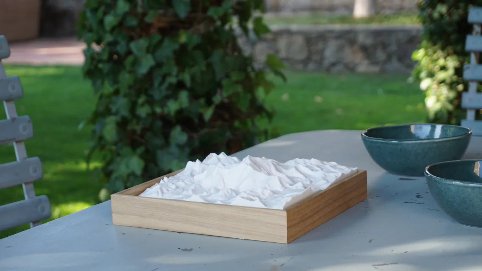 3D city map wall art with wood frame on outdoor table, decorative cityscape model