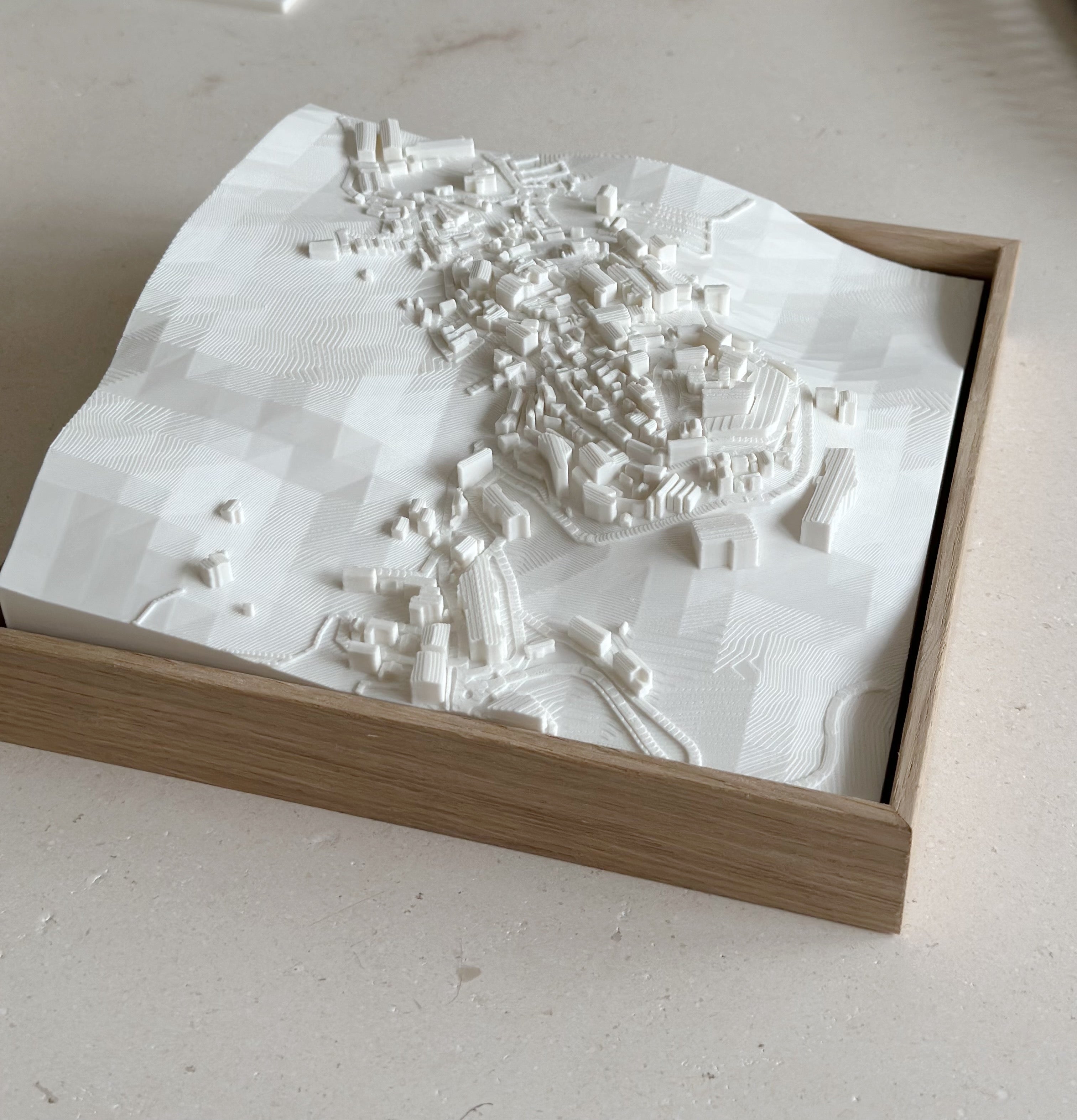 3D city map wall art in a wooden frame, white topographic urban model decor