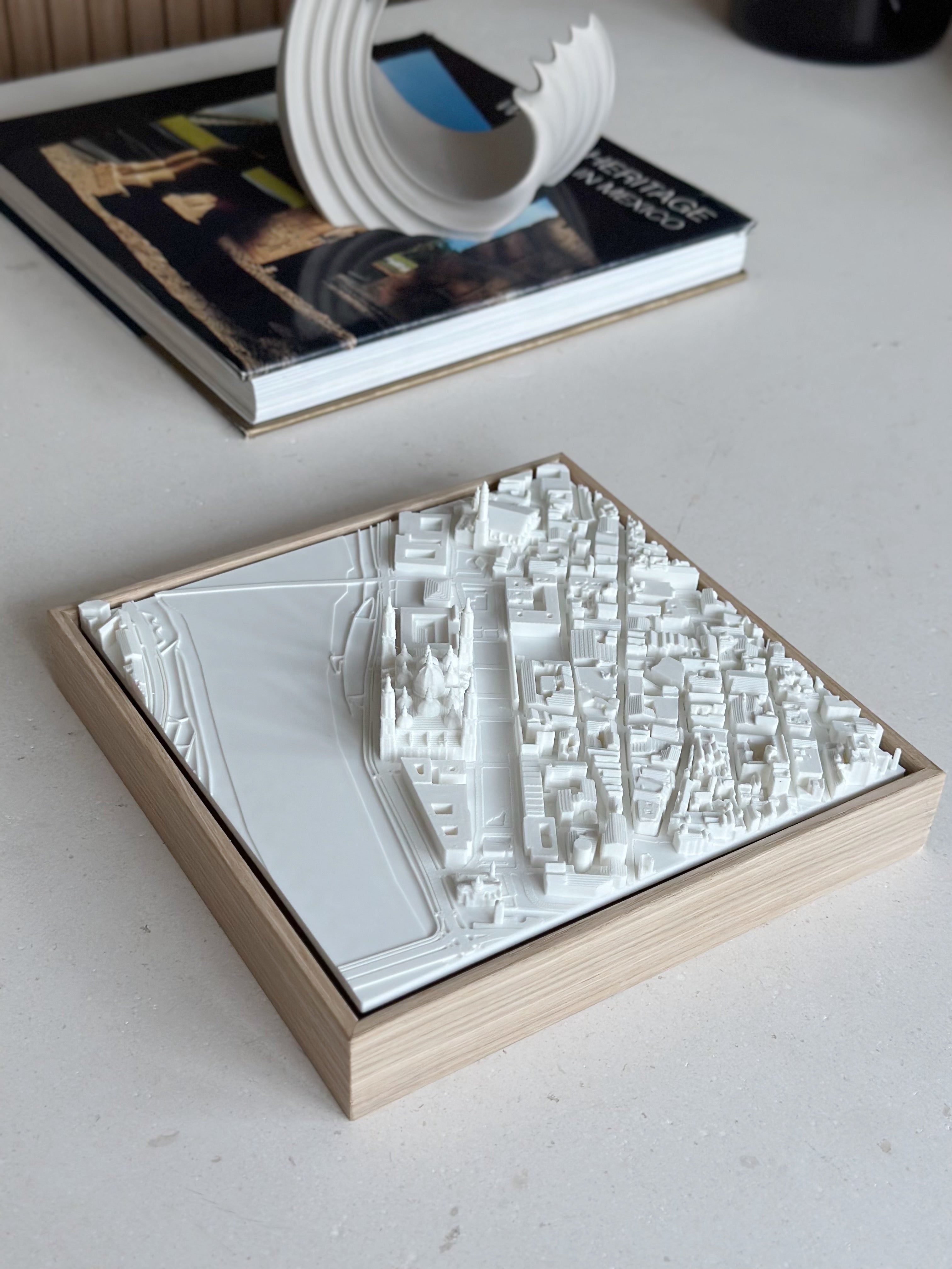 3D city map wall art in a wooden frame on a table, modern home decor accent.