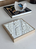 3D city map wall art in a wooden frame on a minimalist table, modern home decor