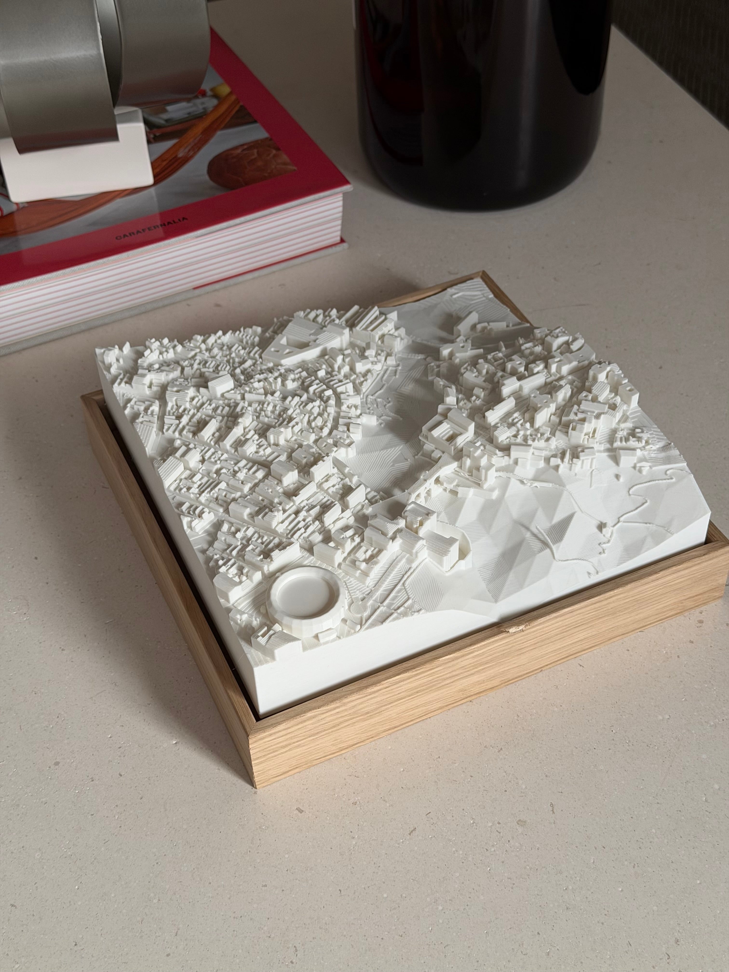3D city map sculpture in wooden frame on a table, modern home decor