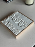 3D city map wall art in a wooden frame on a light table, modern urban decor