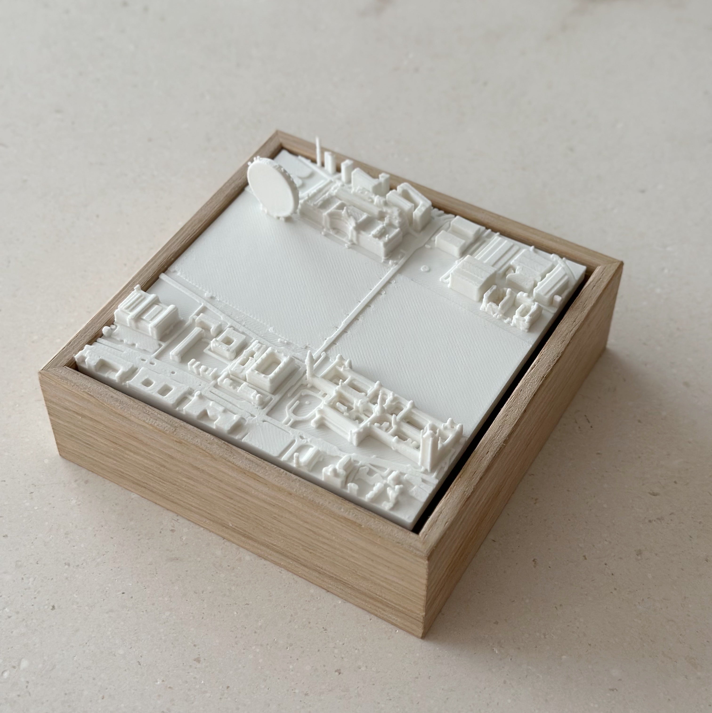 3D city map wall art in a wooden frame, white model with detailed buildings