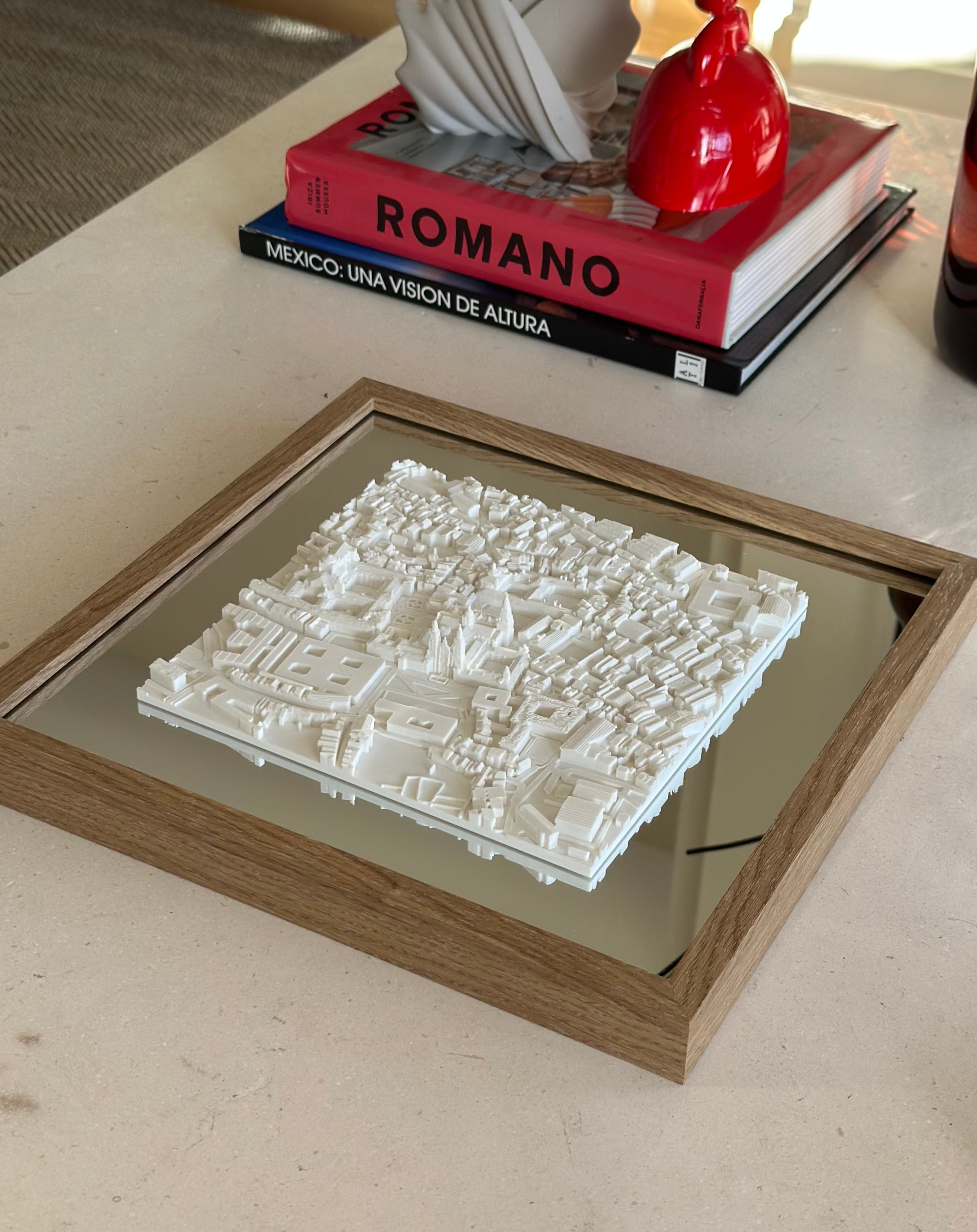 3D city map wall art in wood frame on modern coffee table with decor books