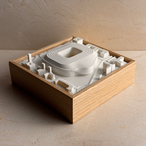 3D city map wall art in a wooden frame featuring detailed architectural structures