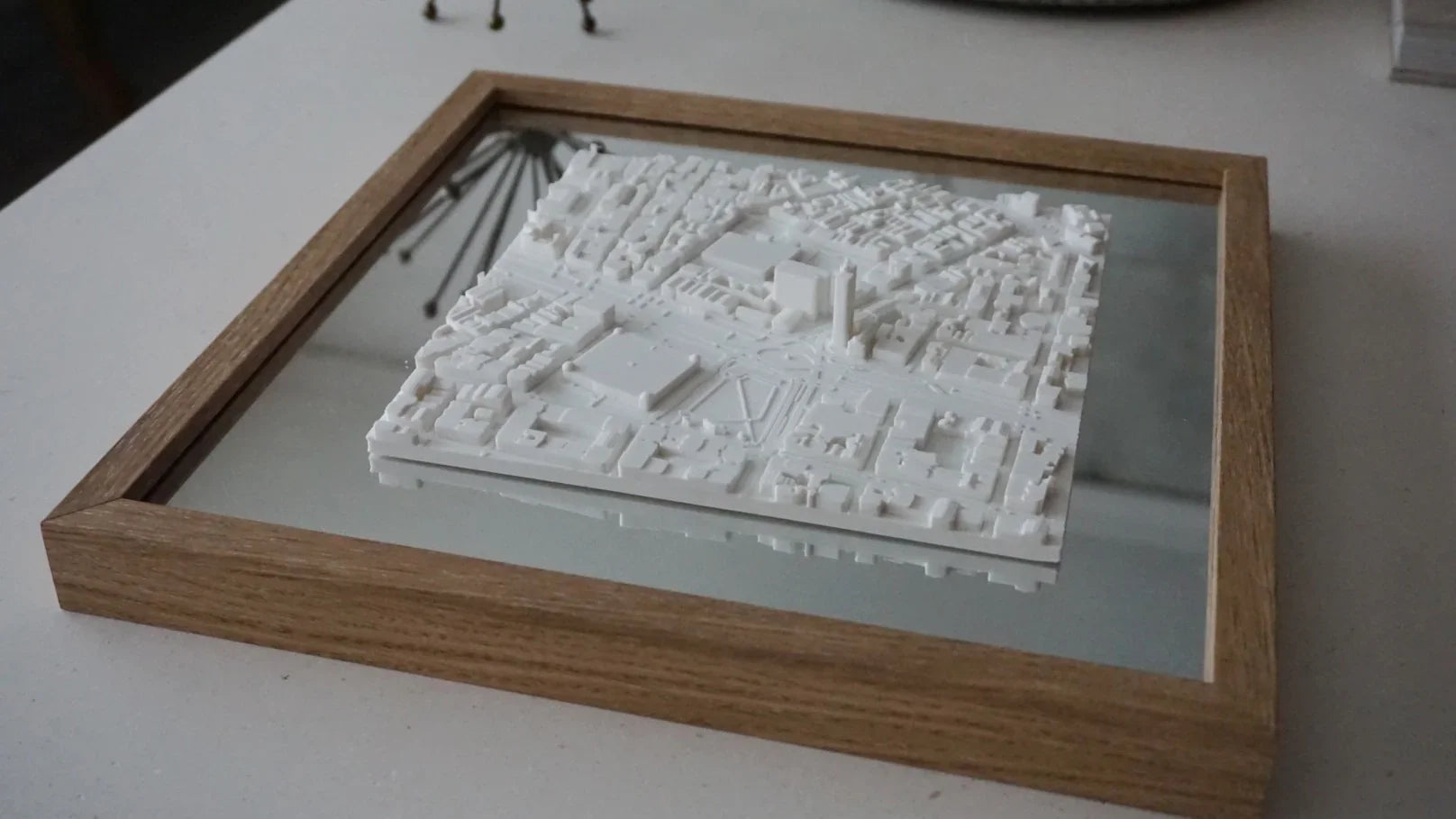 3D city map wall art with wooden frame, minimalist urban decor on a table
