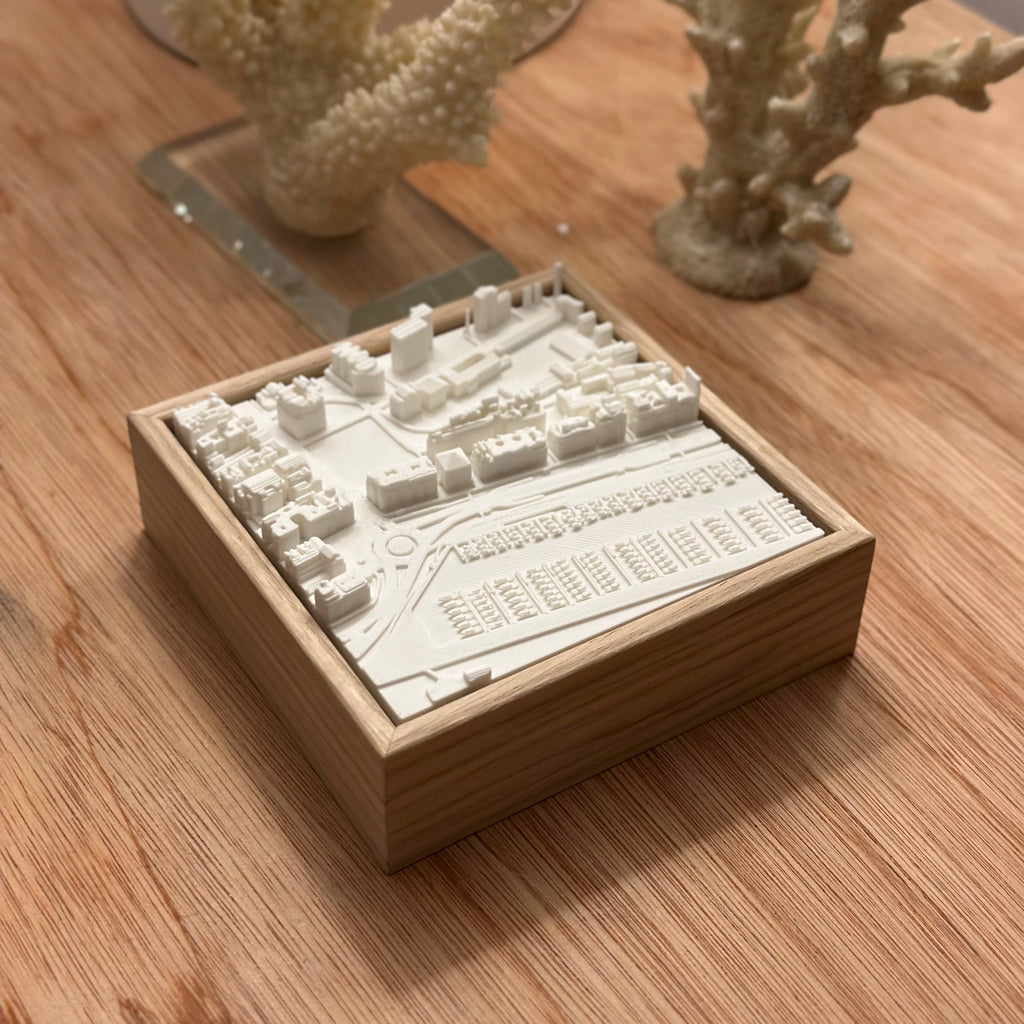 3D city map artwork in a wooden frame on a wooden table, modern decorative piece
