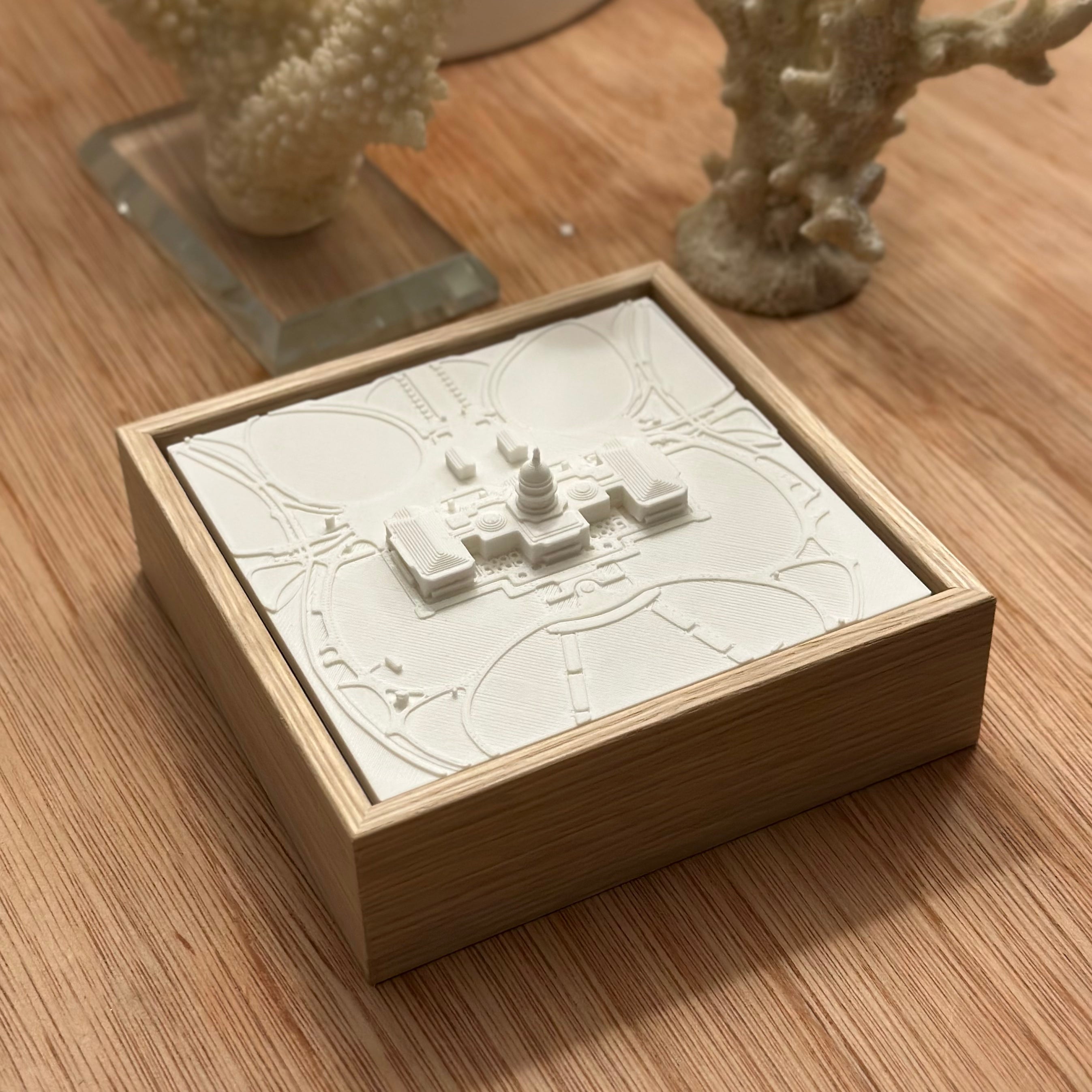 3D city map wall decor in a wooden frame on a wooden table with decorative coral