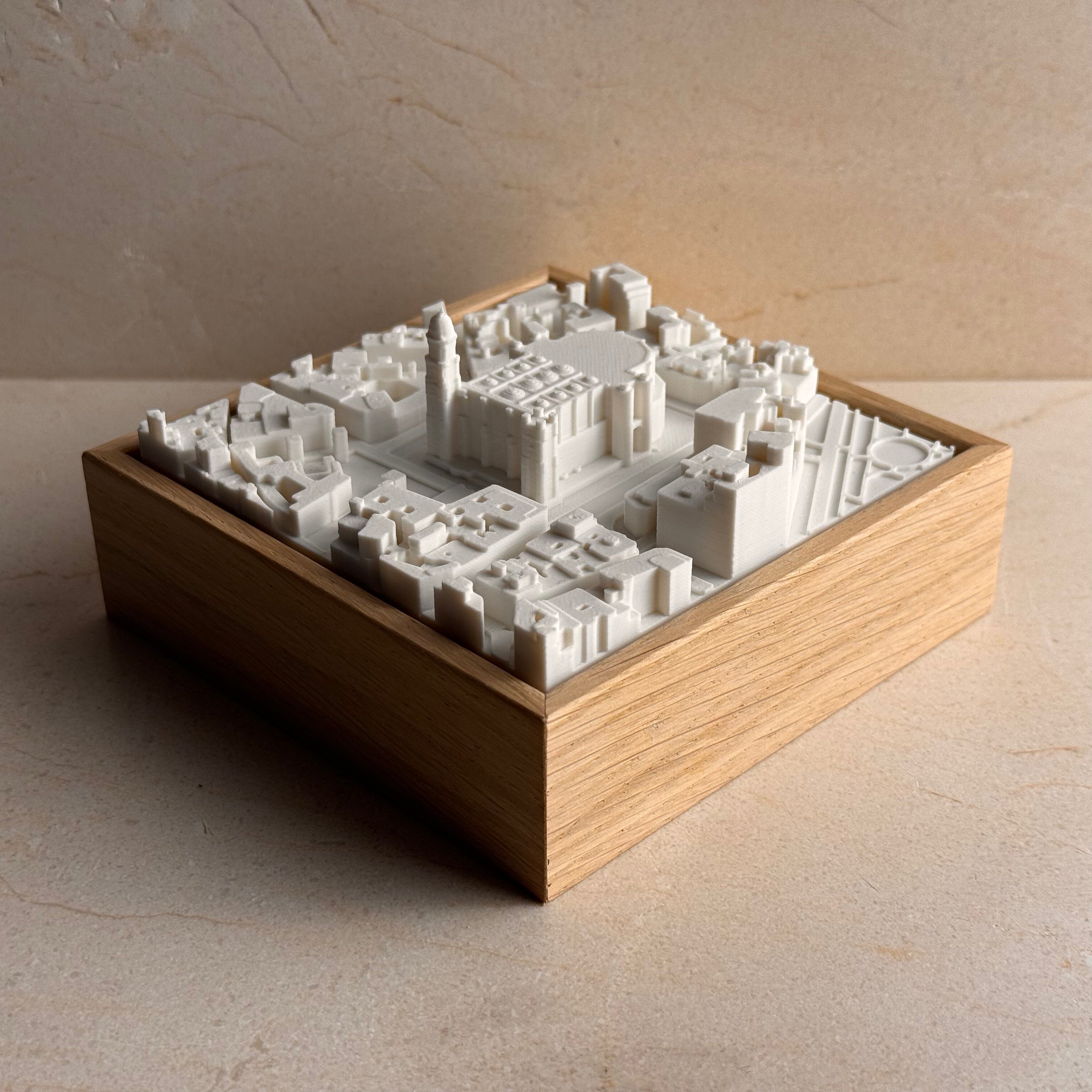 3D city map of Malaga in white on wooden frame, decorative miniature sculpture