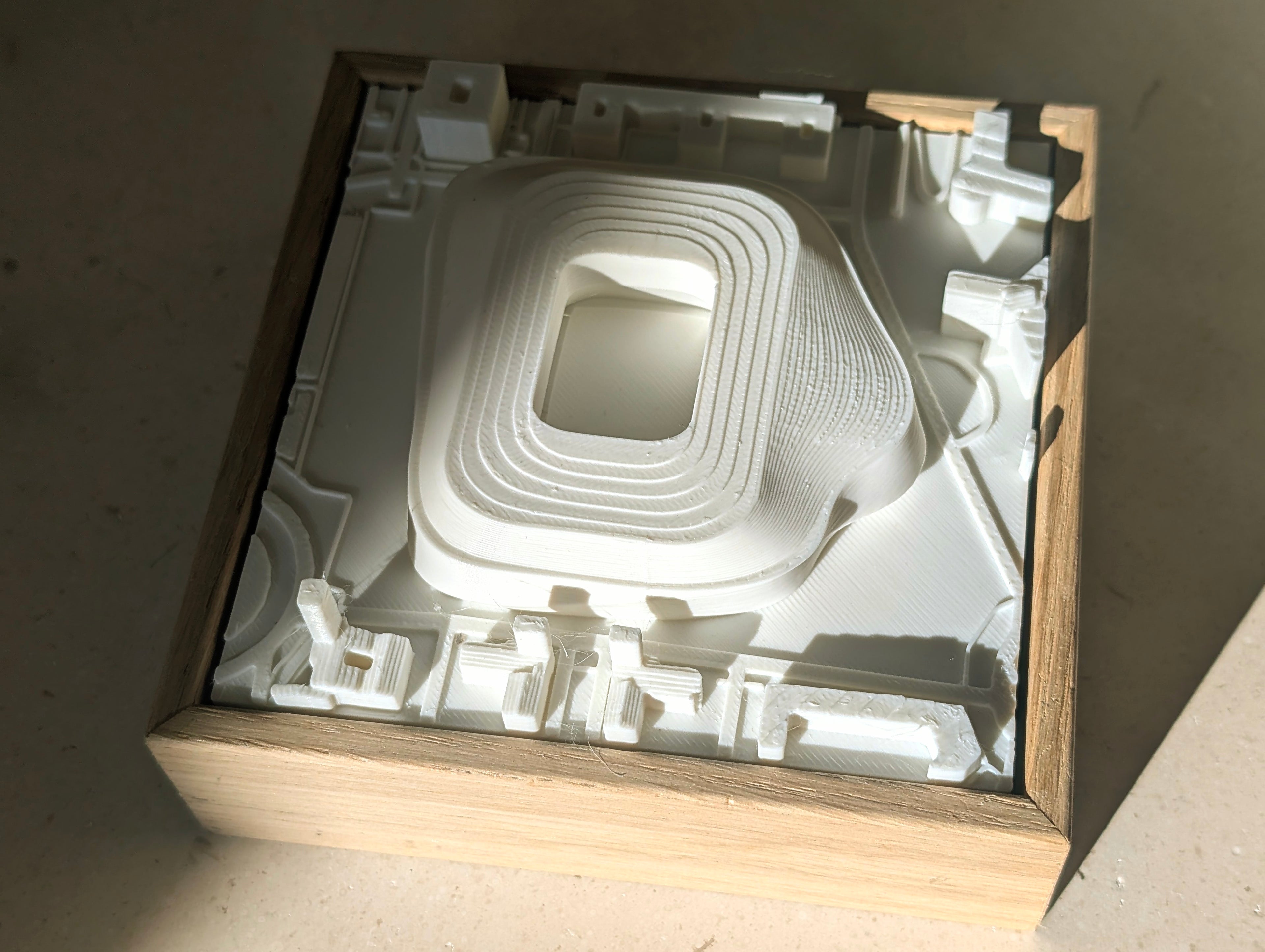 3D city map wall art with white topographic layers in a wooden frame, minimalist decor