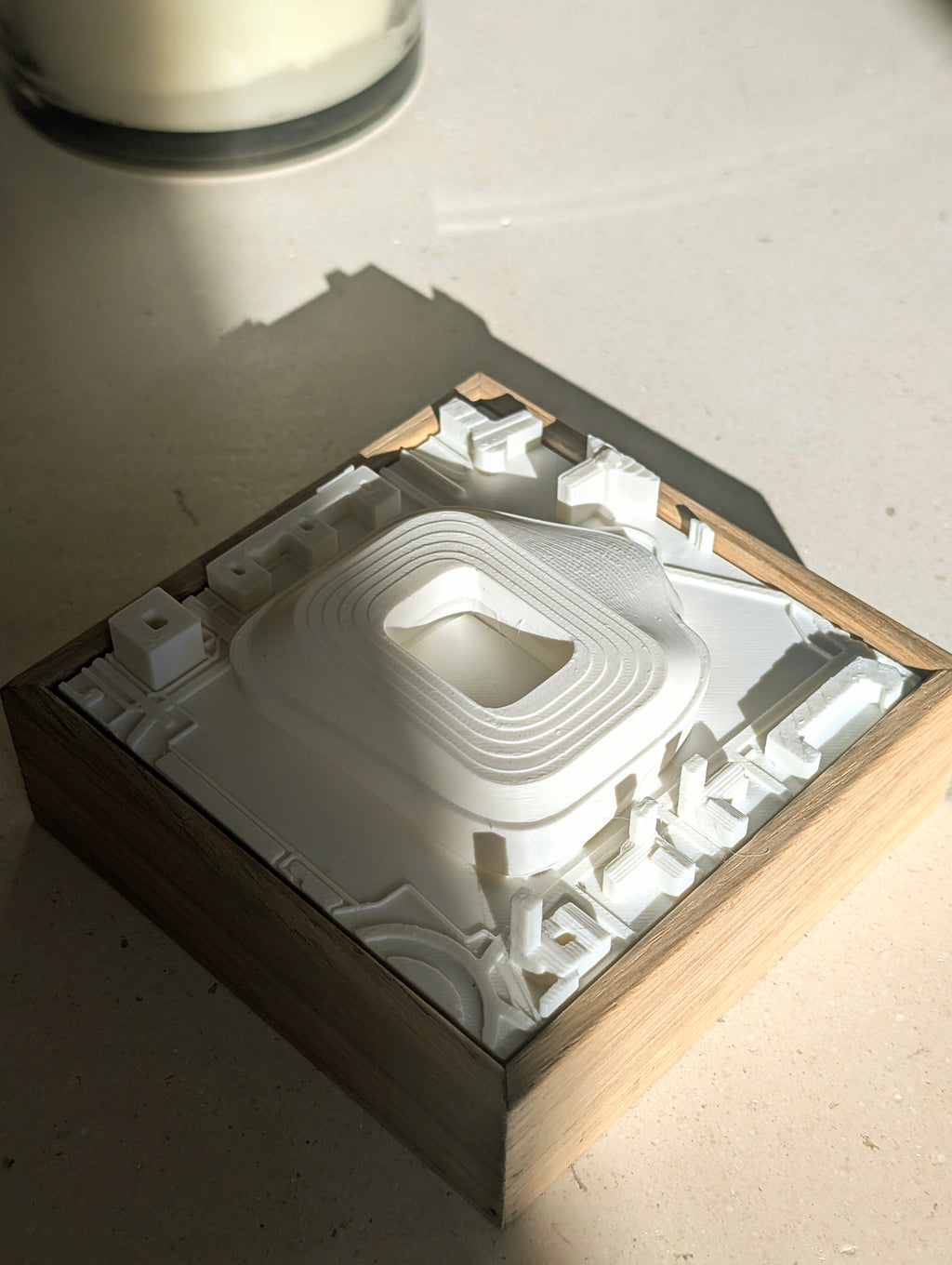 3D city map wall art in a wooden frame with raised architectural details