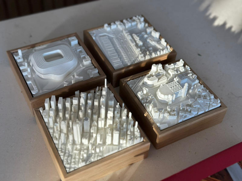 Set of four 3D city map miniatures in wooden frames, featuring detailed urban landscapes