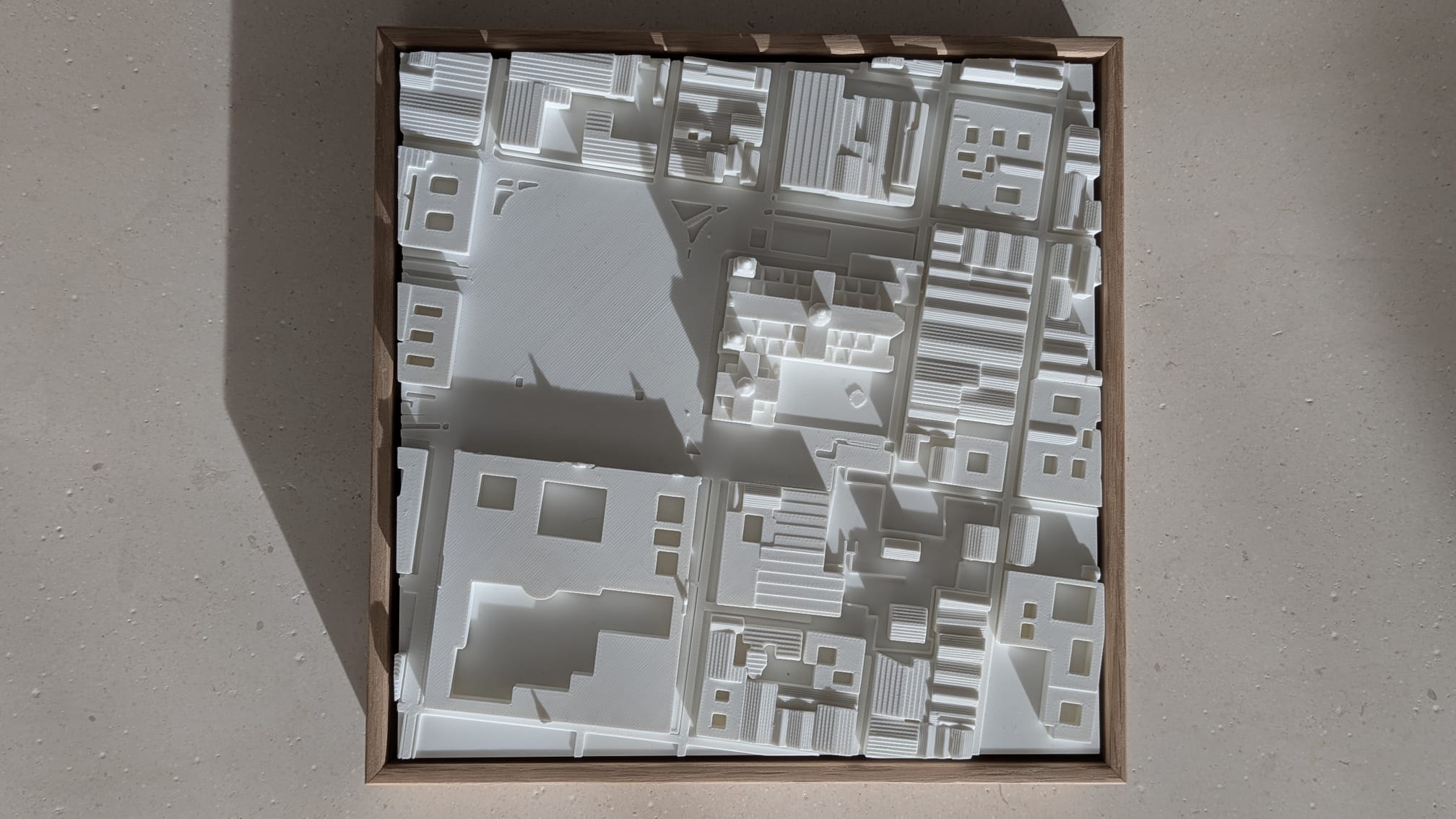 3D city map wall art in a wooden frame, showcasing detailed urban buildings and streets