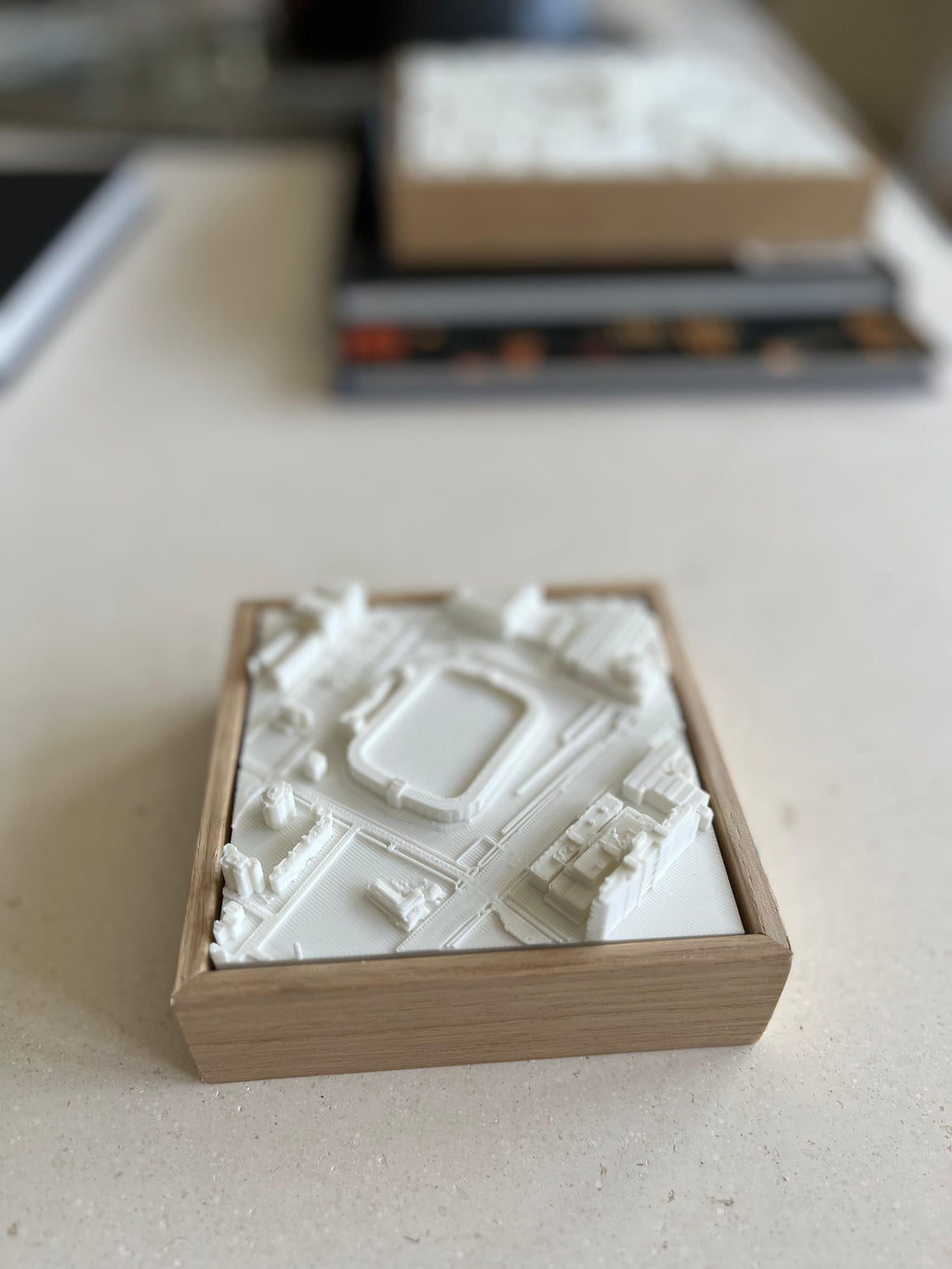 3D city map artwork in a wooden frame on a table, architectural decor