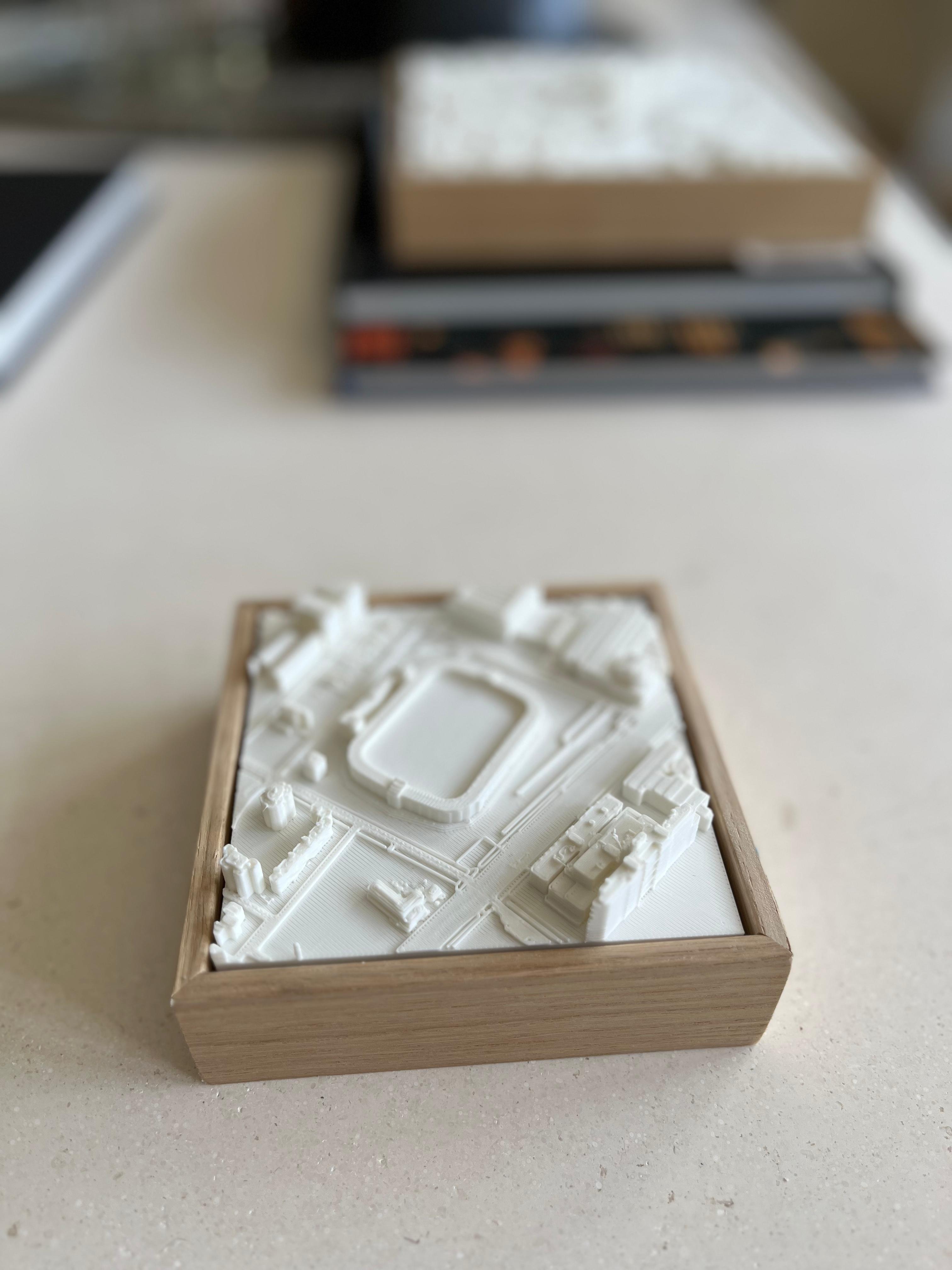 3D city map artwork in a wooden frame on a table, architectural decor